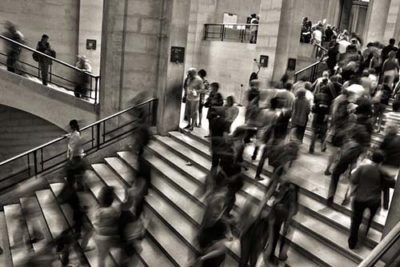 Black and white timelapse image of people walking on stairs